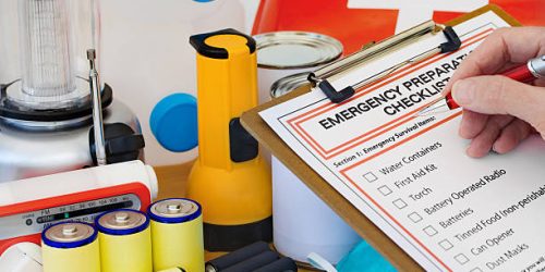 Ready for disaster – checking off the items on the emergency preparedness form Ready for disaster - checking off the items on the emergency preparedness form